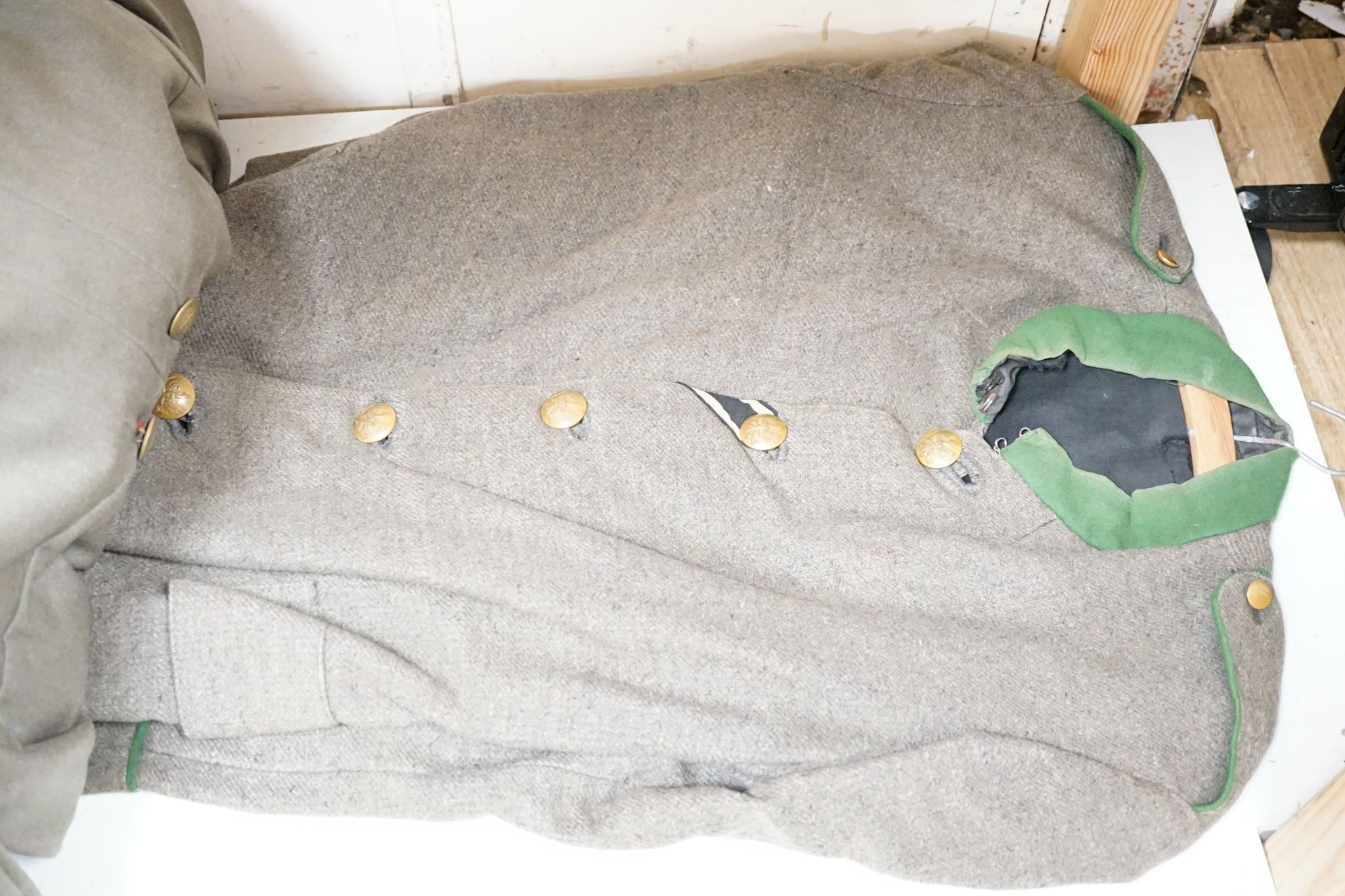 Two German WWI jackets and a similar British jacket.